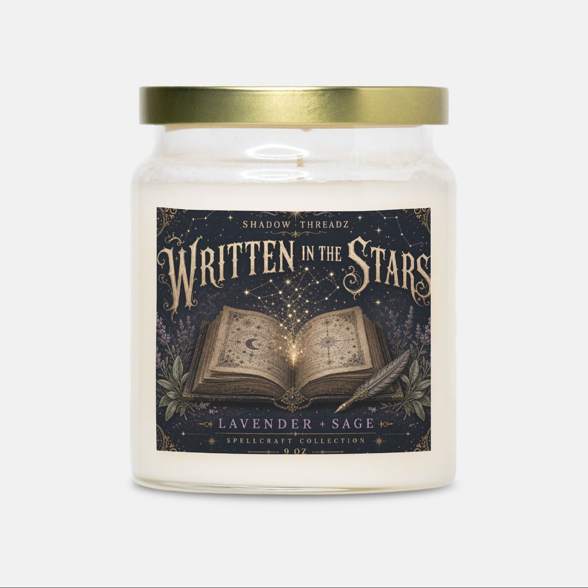 A glass jar candle with a gold metal lid and a dark illustrated label reading 'Written in the Stars' and 'Lavender + Sage' from The Enchanted Collection, centered on a light gray background.